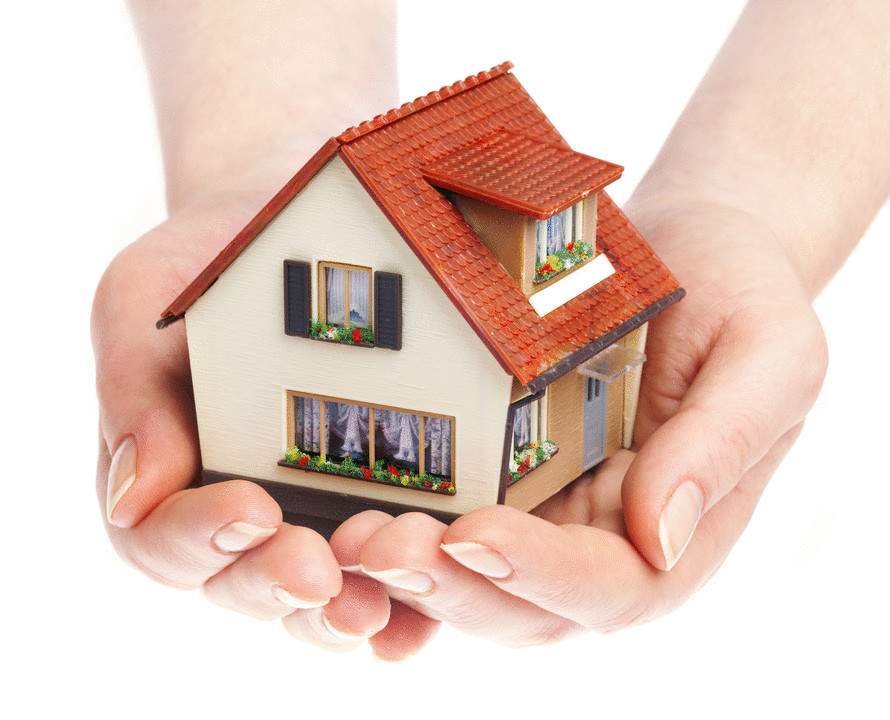 Hands holding miniature house symbolizing homeowners insurance protection and property coverage