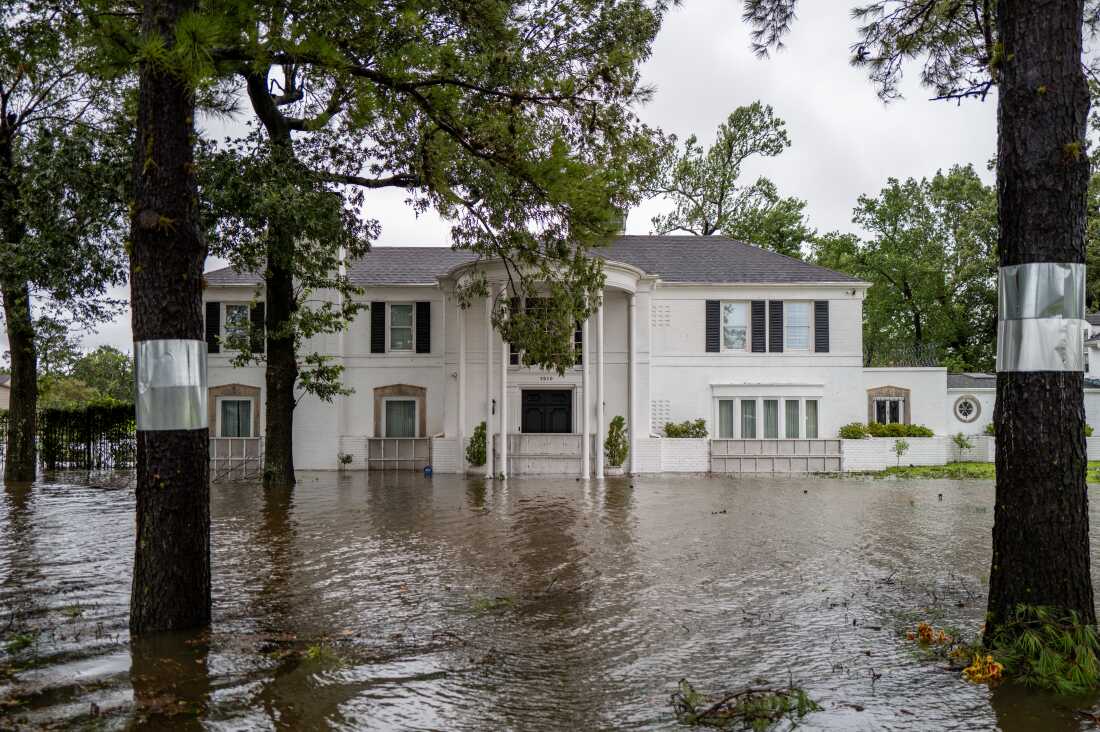 Flooded residential home emphasizing the importance of homeowners and flood insurance coverage