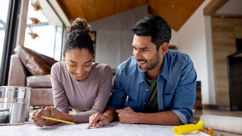 Couple reviewing home plans together highlighting homeowners insurance protection for residential property
